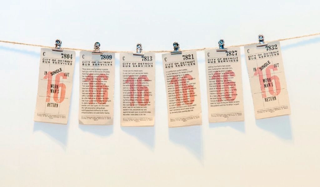 Artwork from exhibit, postcards hanging on a string