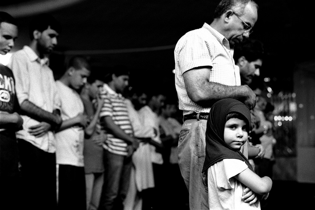 1. Young Girl at Prayers with Her Father, Muslim American Society, Brooklyn NY, gelatin silver photograph, 16”x20” (2010)