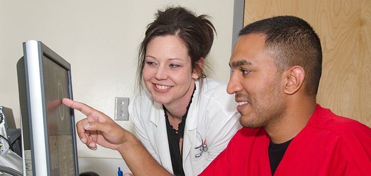 Four female Radiologic Technology students working in the lab