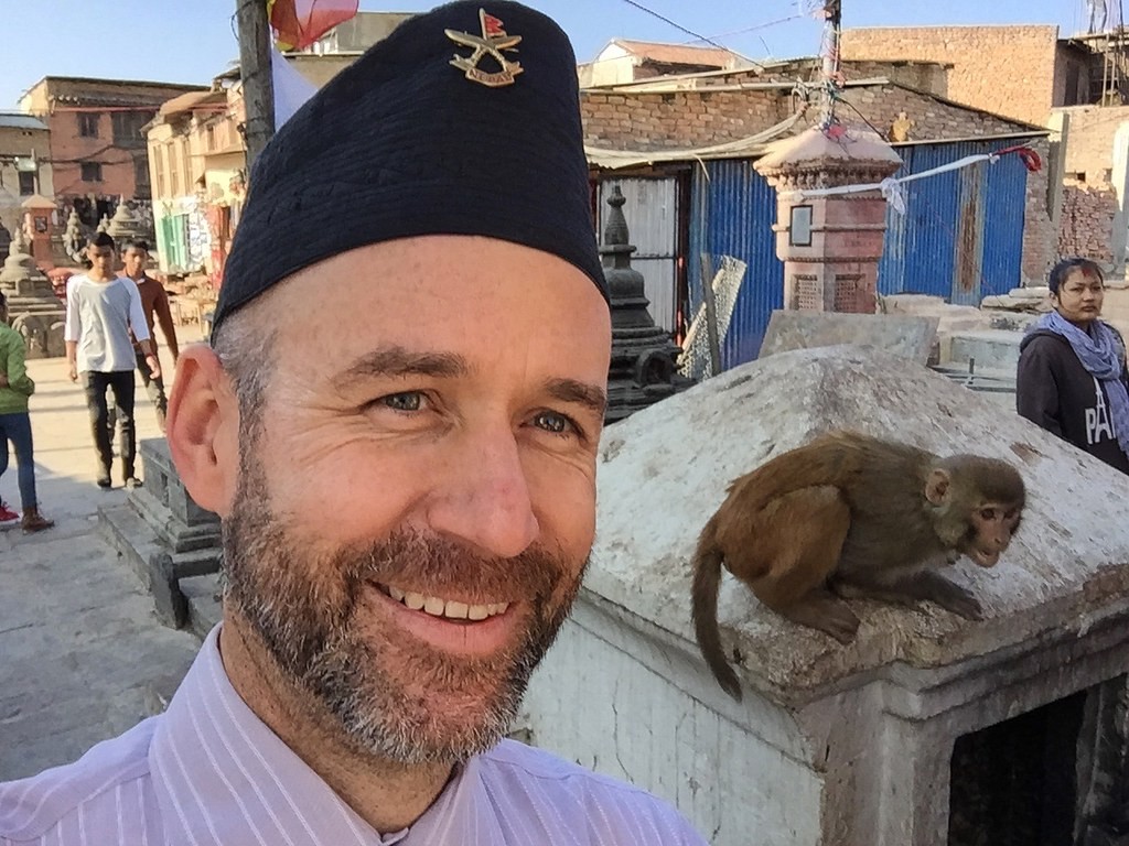two men smiling for camera at stadium