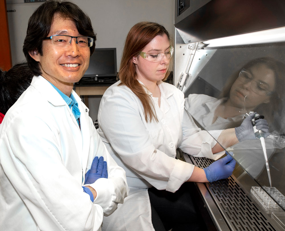 Professor Yoshi Odaka in the lab with a student