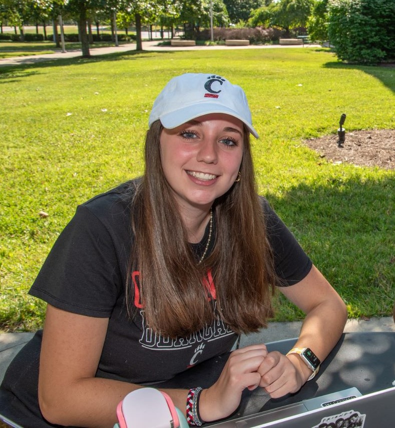 female student in UC hat