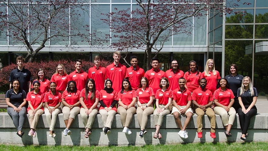 Student ambassdor group sitting outside