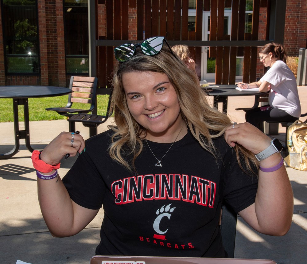 Liz Guckiean outside on the UC Blue Ash campus patio
